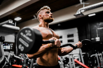 Athlete training with dumbbells in the gym