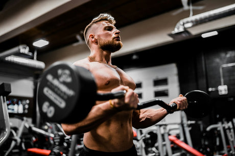Athlete training with dumbbells in the gym